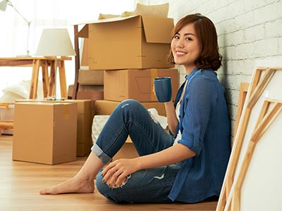 Smiling woman unpacking art move