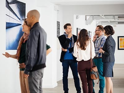 People in an art gallery looking at artwork