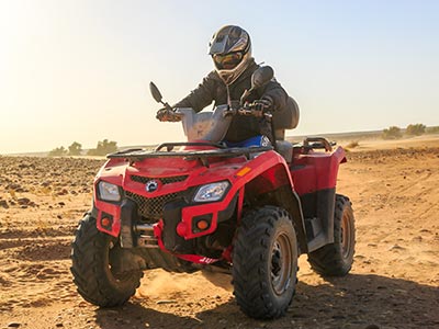 Person unloading red ATV after transport