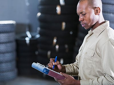 Man reviewing inventory at auto parts store