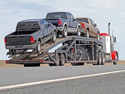 Trucks being transported on car carrier