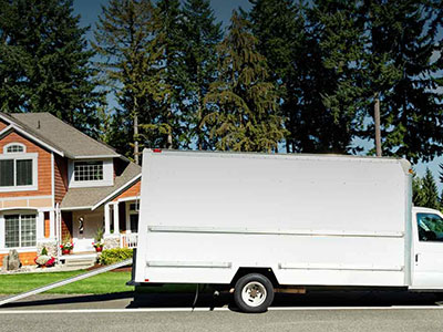 White glove moving truck in front of a home
